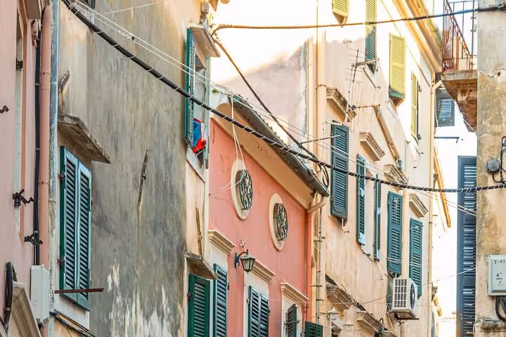 Colorful Old Corfu Town alley with Venetian buildings and shuttered windows on a private walking tour