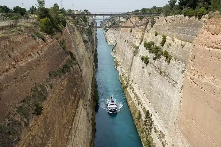 Boat cruising the Corinth Canal, iconic highlight on a 2-day Peloponnese tour from Athens, Greece