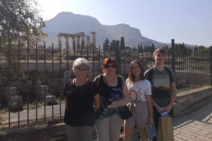 Guests posing by Ancient Corinth ruins on Corinth Canal day trip from Athens with wine tasting and workshop