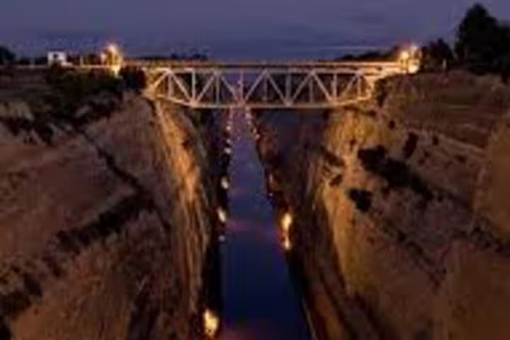 Corinth Canal at dusk with illuminated bridge, scenic stop on the Ancient Corinth and Corinth Canal tour from Athens