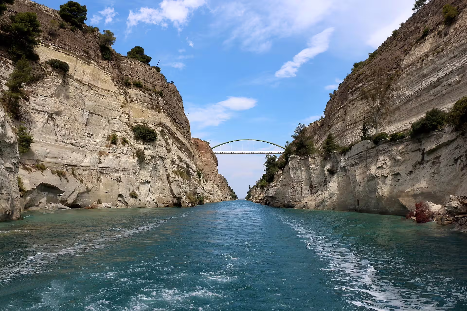Corinth Canal cliffs and bridge seen from boat, highlight on private Athens day trip to Nafplio, Mycenae and Epidaurus