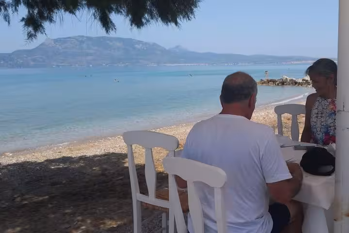 Seaside taverna lunch stop on Athens to Corinth Canal day trip, relaxing by the beach after wine tasting