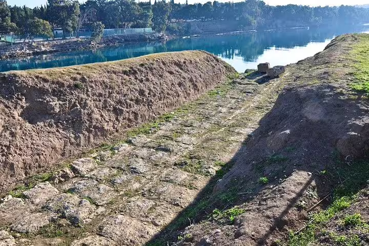 Stone path along the Corinth Canal viewpoint, scenic stop on an Ancient Corinth half-day tour from Athens