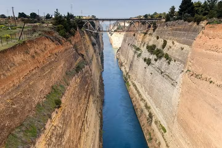 Corinth Canal viewpoint with steep cliffs and bridge, stop on private luxury tour from Nafplio