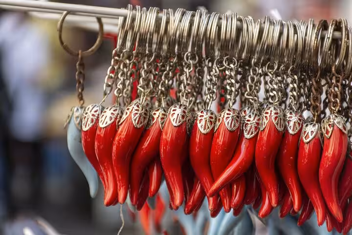 Colorful cornicello keychains on display at a Naples street market, capturing local culture and charm.