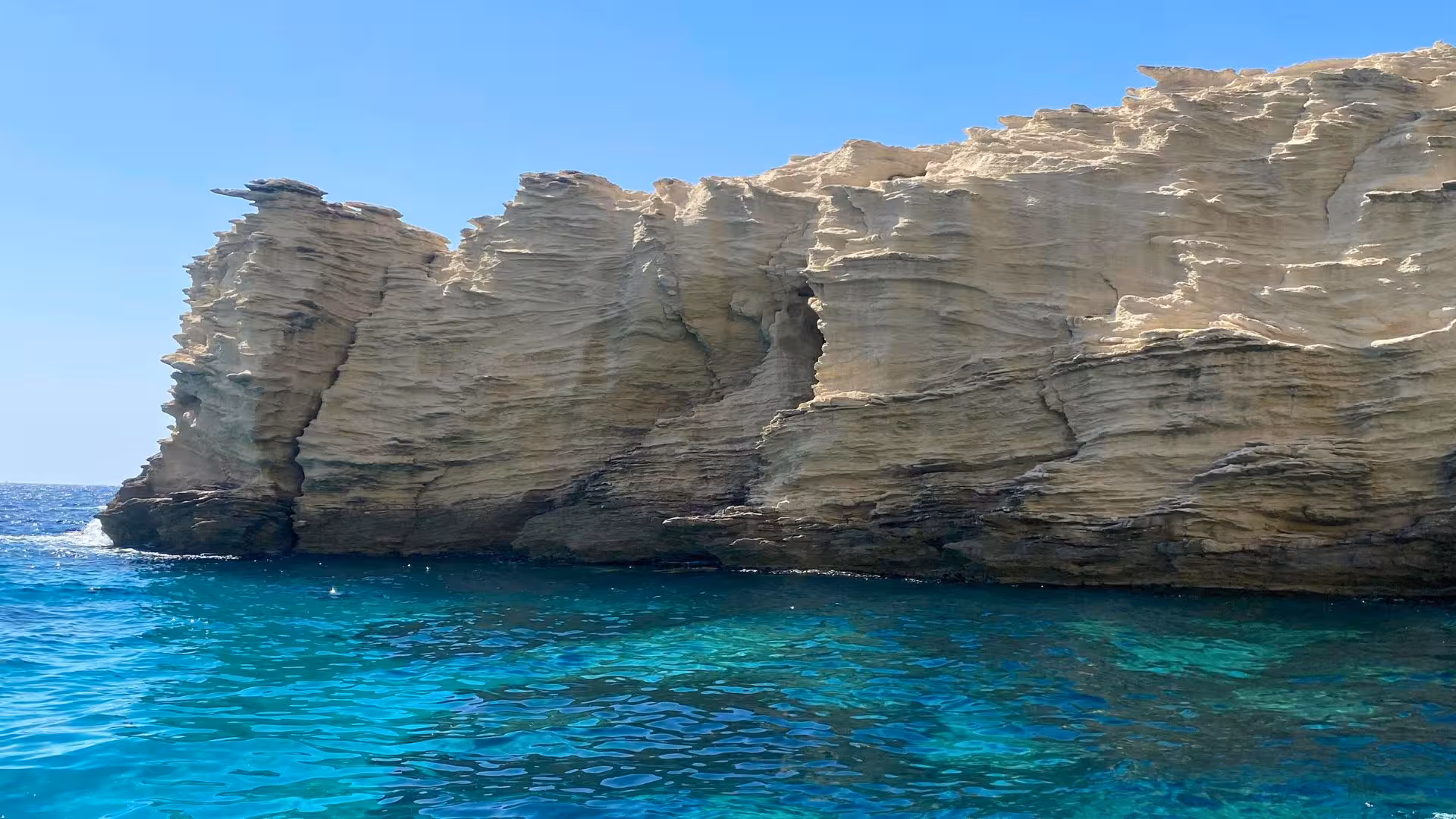 Dramatic limestone cliffs and crystal-clear waters on a RIB tour of southern Corsica from Palau or La Maddalena.