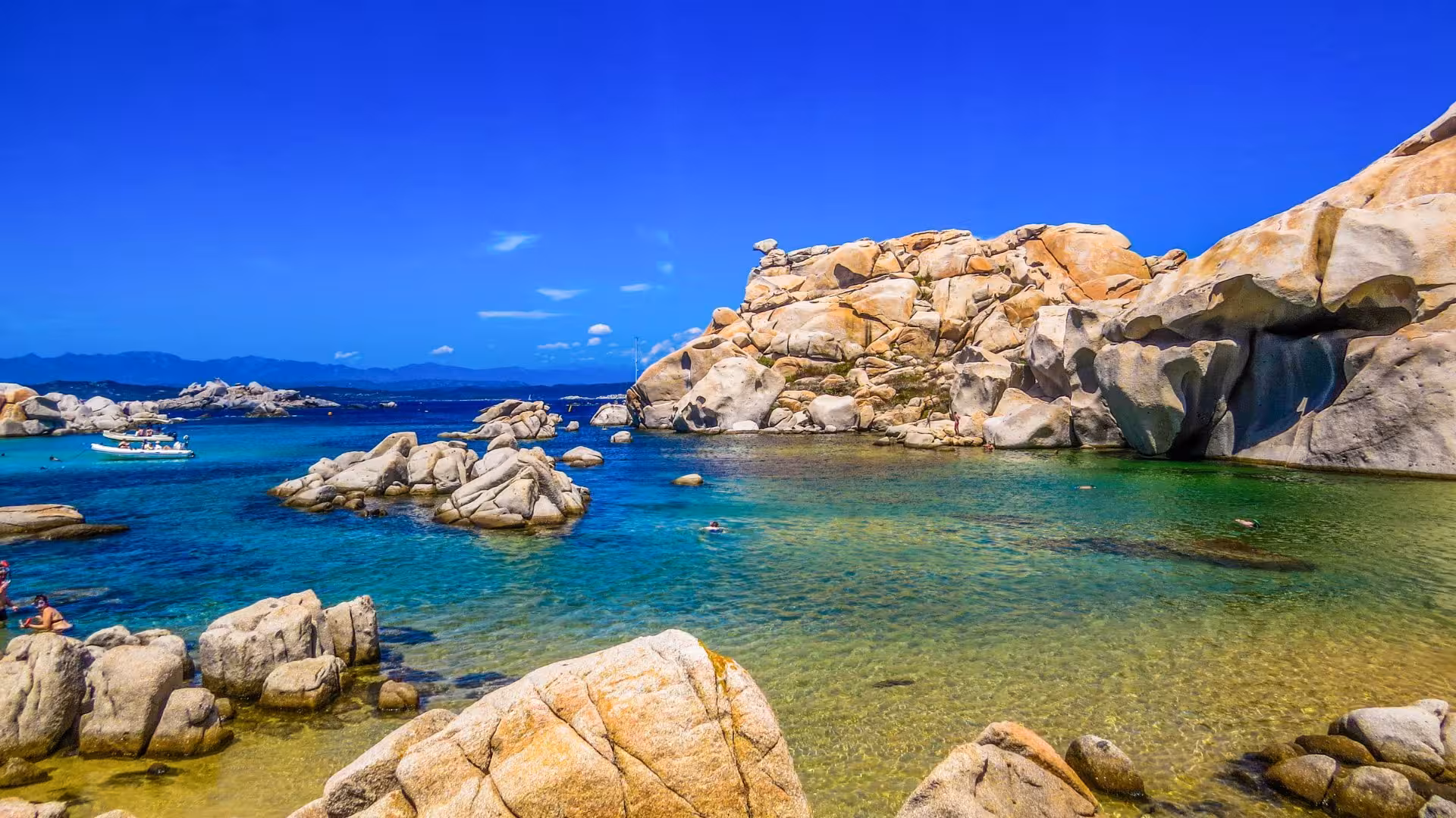 Scenic view of large rock formations and turquoise waters on a southern Corsica RIB tour near Palau and La Maddalena.