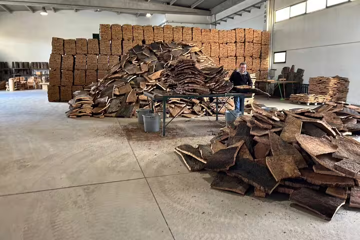 Inside the Cortiza and Herdade Alentejo Factory with stacked cork bark for processing, showcasing traditional techniques.