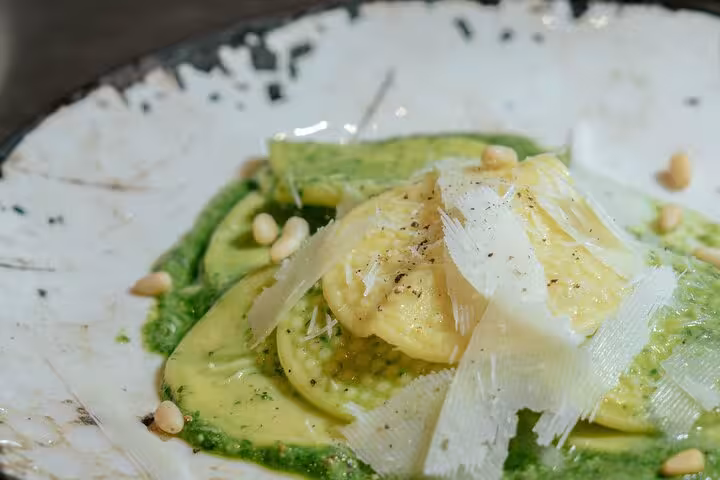Delicious plate of Corzetti pasta topped with pine nuts and cheese, served at MaMa Florence cooking class.