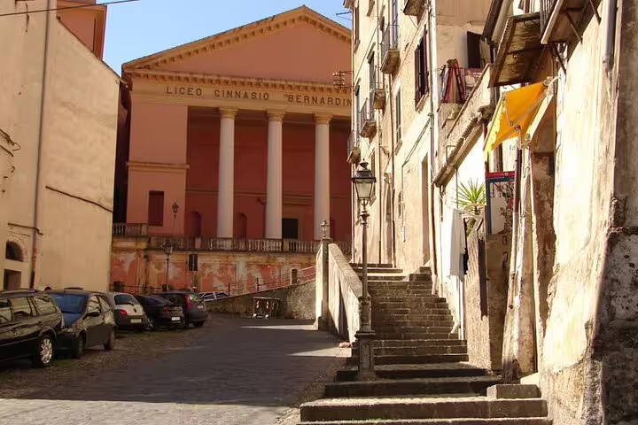 Quiet old town street in Cosenza leading to neoclassical Liceo Ginnasio on an immersive private walking tour