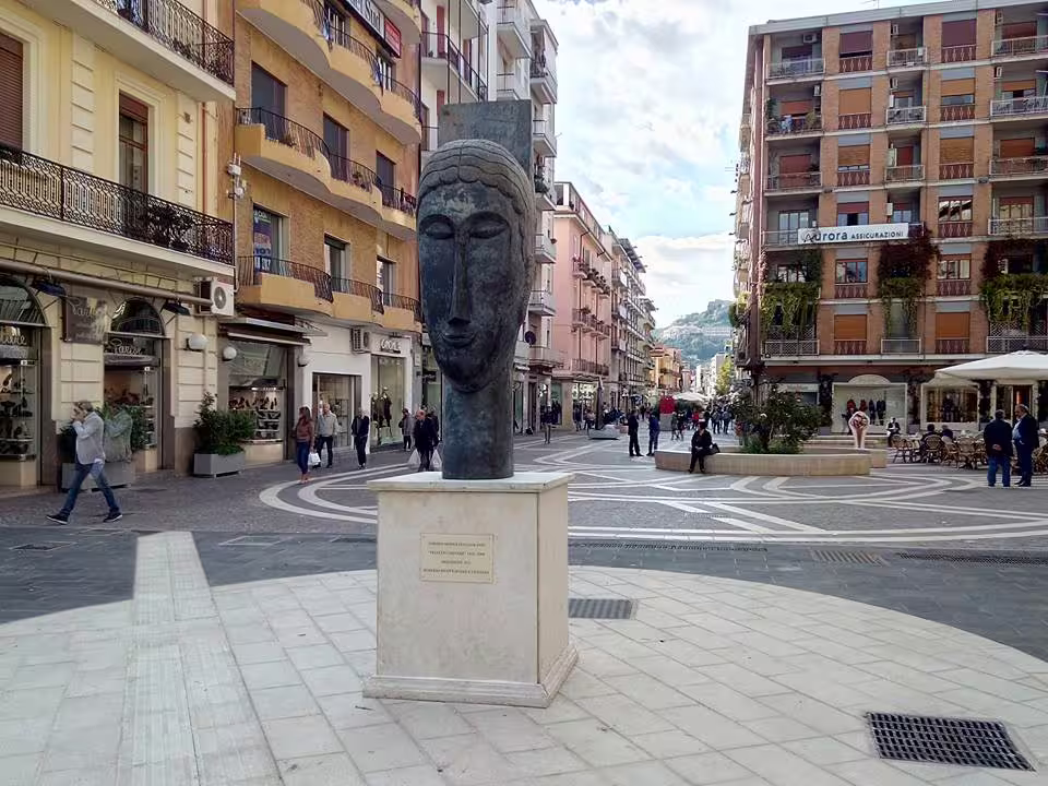 Modern sculpture and lively shopping street in central Cosenza, a cultural stop on a 4-day Calabria and Tyrrhenian coast trip