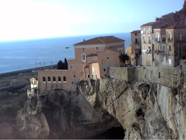Historic cliffside houses overlooking the Tyrrhenian Sea near Cosenza, a scenic stop on a 5-day Calabria travel itinerary