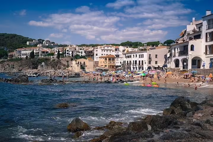 Experience the vibrant beach life and picturesque coastal views in a lively Costa Brava town.