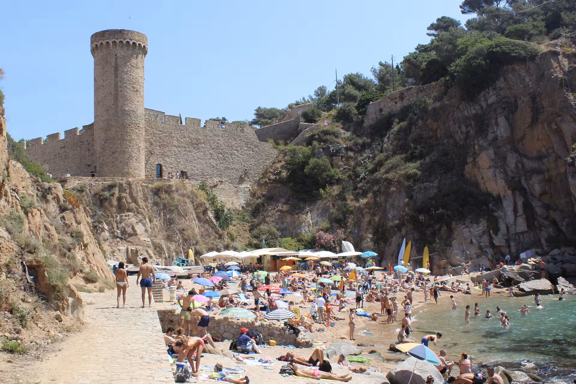 Costa Brava beach cove with medieval Tossa de Mar castle tower, a top day trip from Barcelona