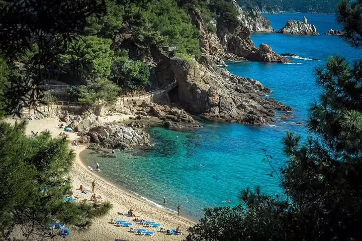 Stunning view of Costa Brava's turquoise waters and rocky coastline, perfect for the Dalí Museum tour adventure.