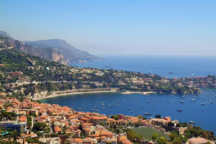 Panoramic Cote d’Azur bay with yachts and terracotta rooftops, Mediterranean coastline view on a Riviera tour