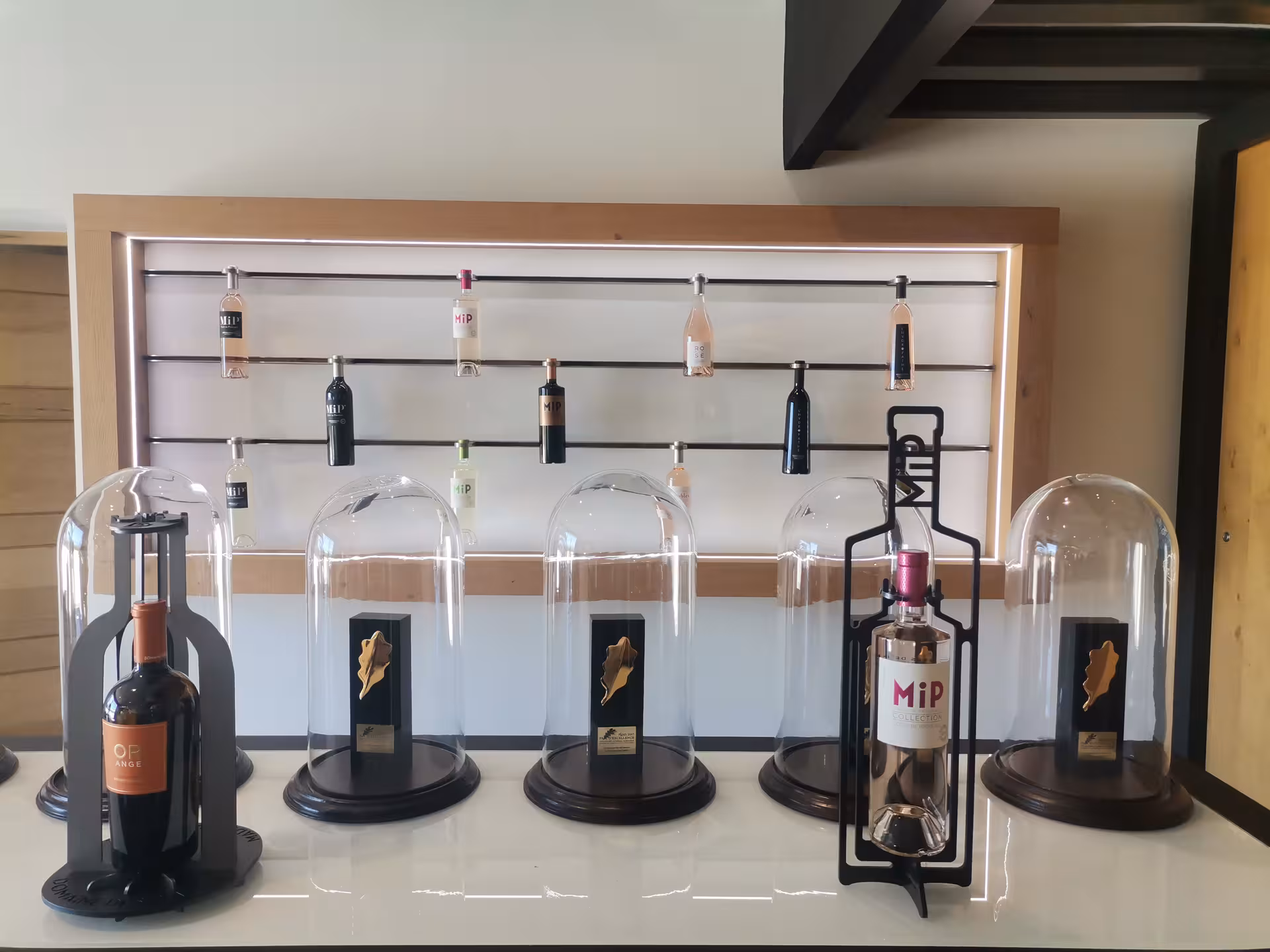 Modern Provence tasting room display of Coteaux d'Aix-en-Provence rosé bottles for Sainte-Victoire wine tour.