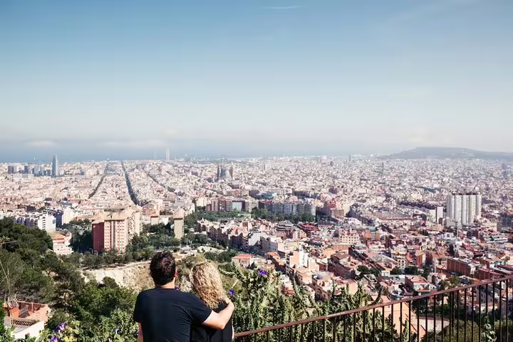 Couple overlooking Barcelona skyline from a scenic viewpoint, photographed on a private personal photographer tour