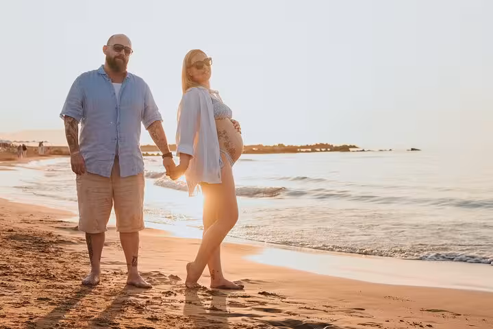 Couple enjoying a serene beach walk in Gouves at sunset, capturing moments for a memorable private photoshoot.