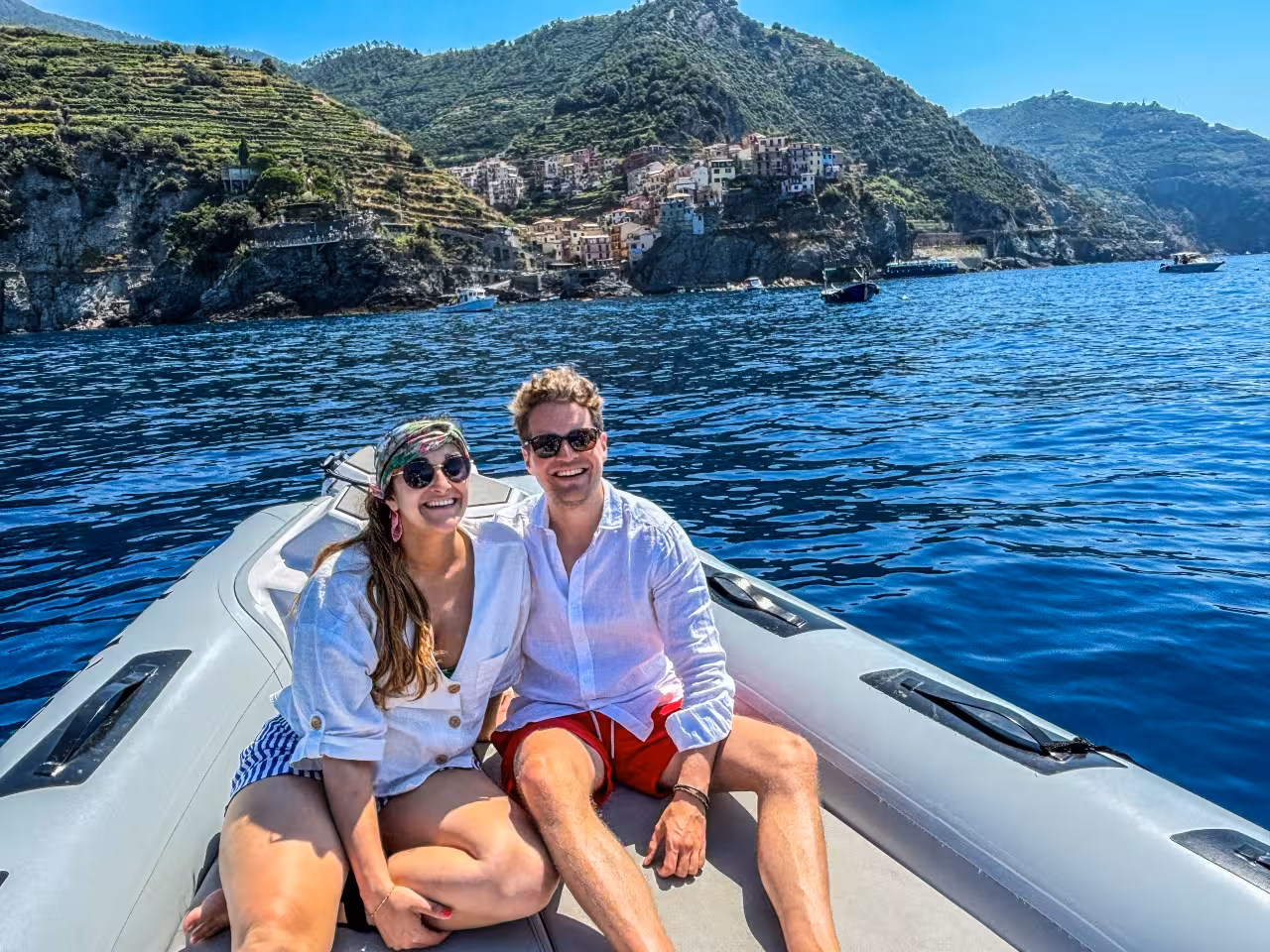 Couple relaxing on a boat near Manarola on a Cinque Terre full-day boat tour from La Spezia