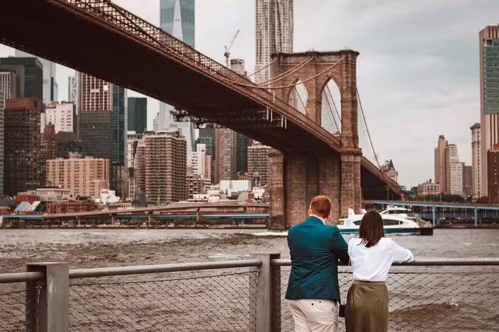 Couple at Brooklyn Bridge Park with Manhattan skyline, ideal New York proposal photographer session by the river
