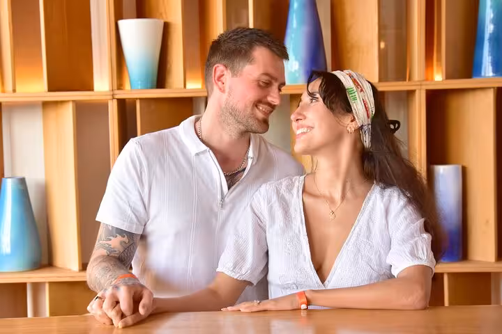 Smiling couple enjoying a relaxed moment at a stylish cafe during a private photoshoot in Hersonissos.