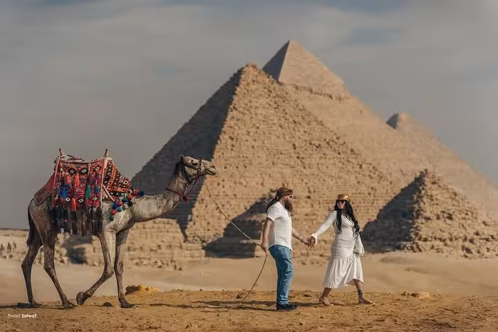 Couple with camel at Giza Pyramids plateau, Egypt, on private tour to pyramids, Sphinx and bazaar