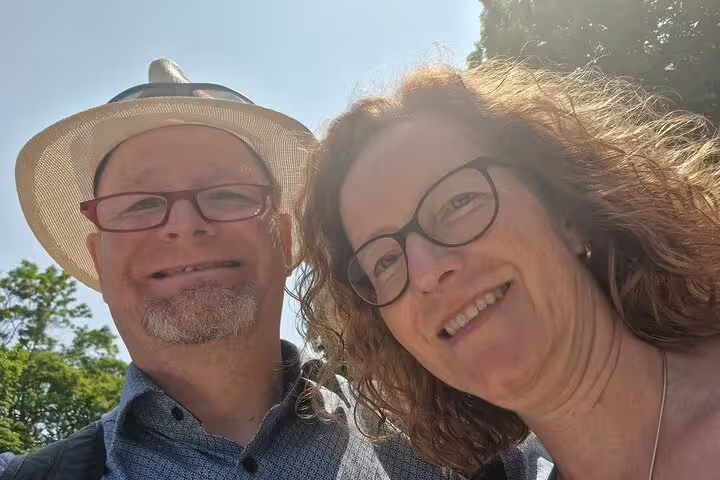 Happy couple selfie in sunny Colmar, exploring highlights on a self-guided scavenger hunt and sights tour