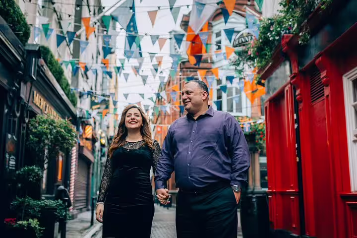 Couple enjoying a vibrant street with colorful bunting in Dublin on a private travel photographer tour.