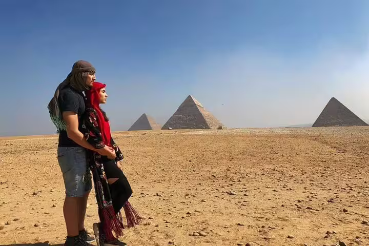 Couple at Giza Pyramids viewpoint on a 2-day private guided Cairo tour with expert Egyptologist guide