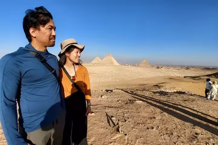 Couple enjoying panoramic view of Giza Pyramids desert on 3-day Cairo pyramids, churches and museums tour
