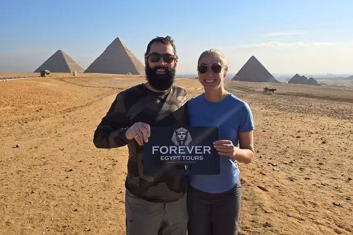 Couple posing in Giza desert with Great Pyramids backdrop on private tour, ideal for ATV quad bike add-on