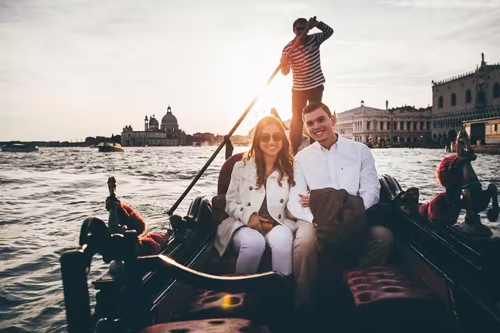 Couple on gondola at sunset near St Mark’s Basin, Venice proposal photographer capturing engagement photos