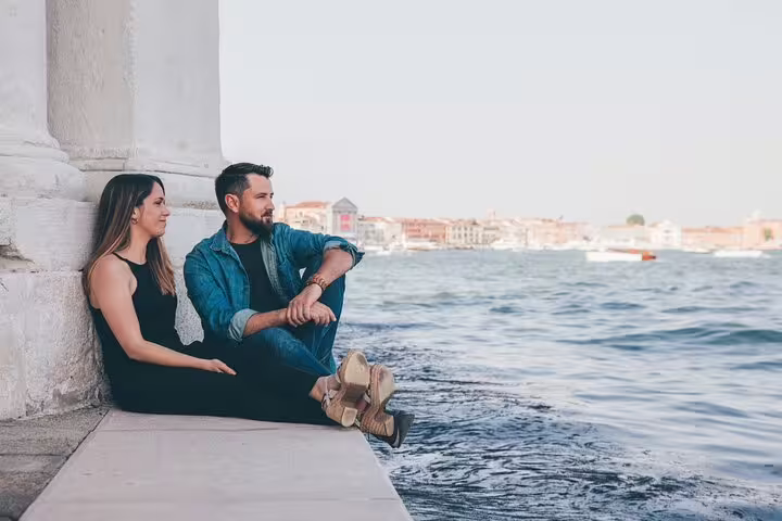 Couple relaxing by the Grand Canal before a private gondola ride with professional photographer in Venice