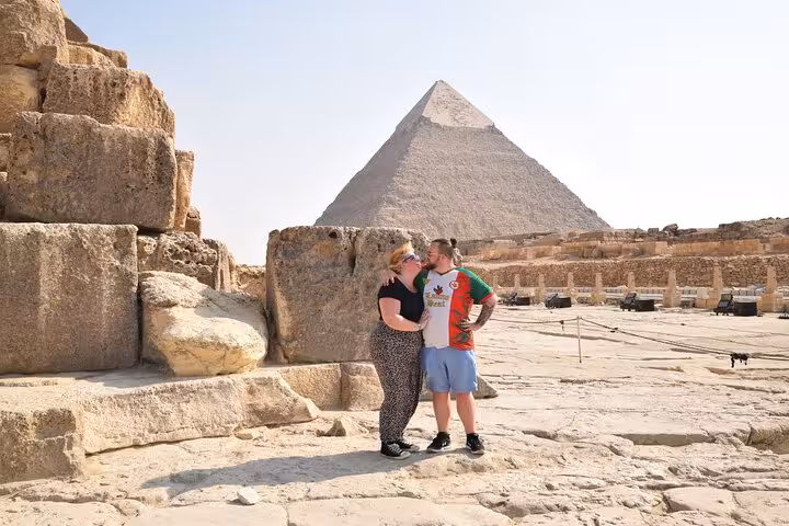 Couple at the Great Pyramid of Giza during a Cairo private tour featuring pyramids, museum and bazaar