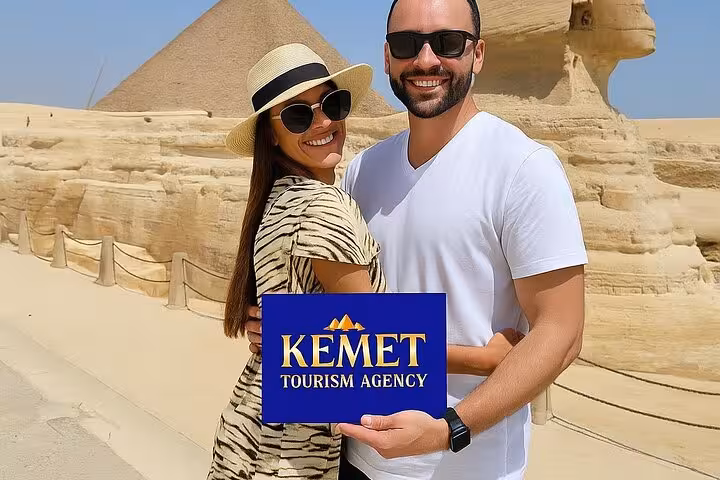 Couple with Kemet sign by the Great Sphinx and Giza Pyramid on a half-day private guided tour in Cairo, Egypt