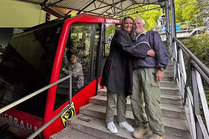Couple enjoying Harderbahn funicular ride on private day trip to Harder Kulm and Grindelwald.