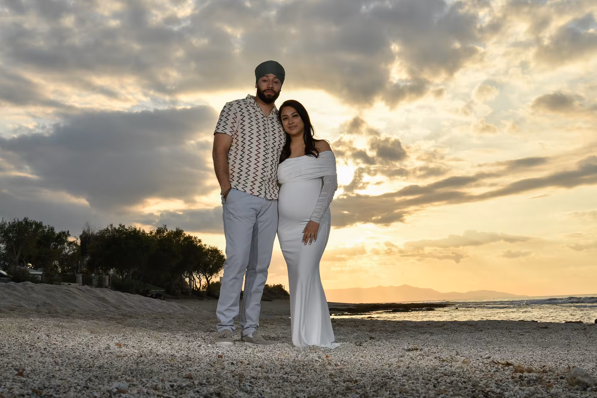 Couple posing on Heraklion beach at sunset for a private photoshoot, capturing romantic moments by the sea.