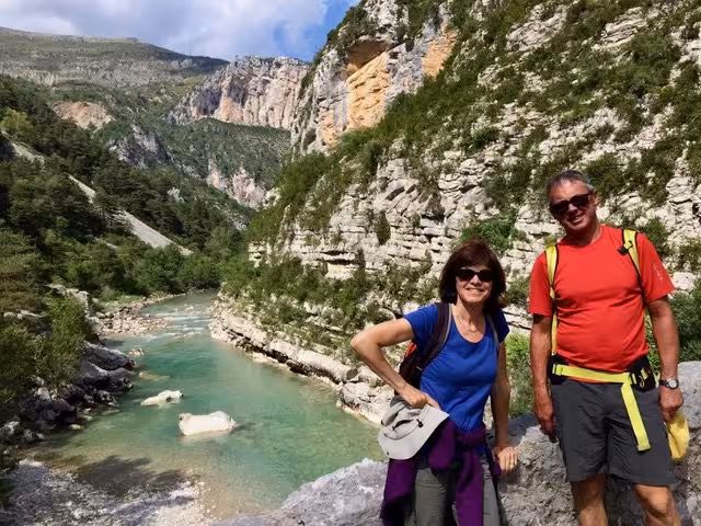 Couple hiking beside turquoise Verdon River in Gorges du Verdon on a 6-day French Grand Canyon trek