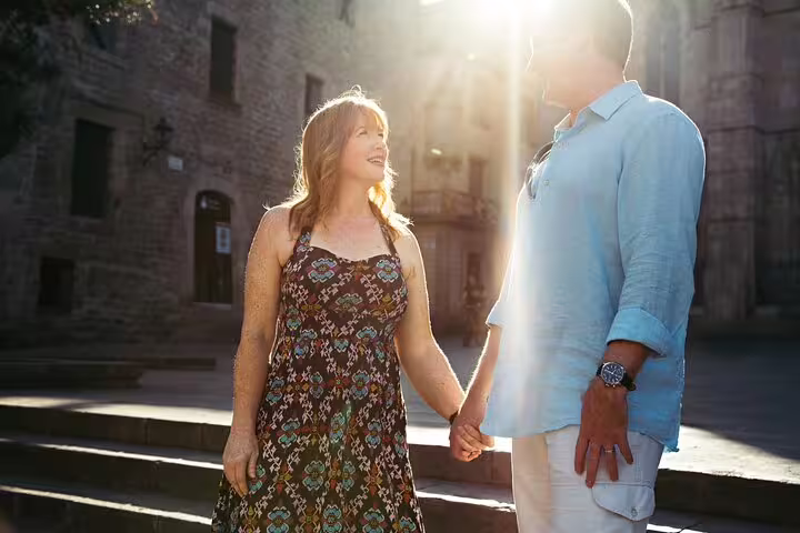 Couple holding hands in golden light on a Rome street during a private 3-hour personal travel photo shoot