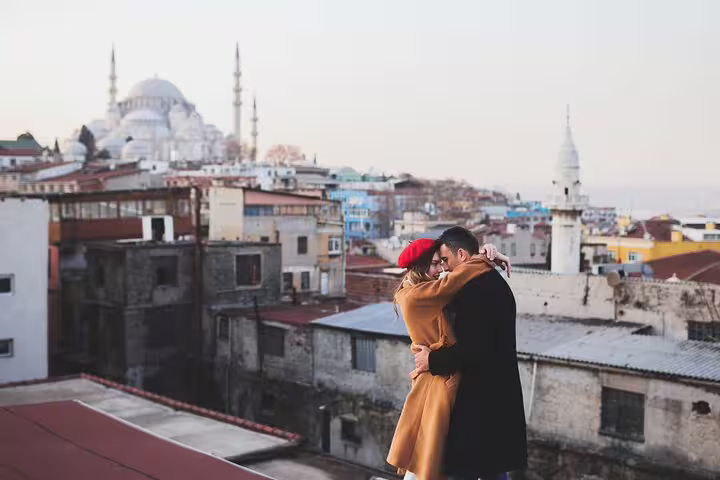 Romantic couple hug on Istanbul rooftop with Süleymaniye Mosque skyline, private vacation photographer session