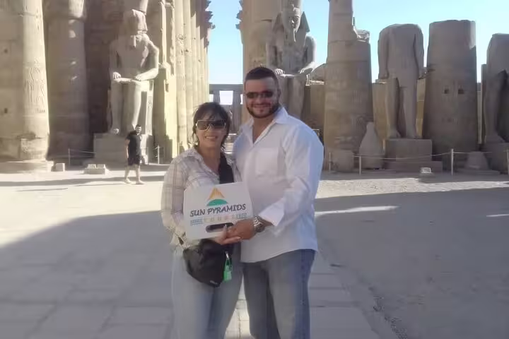Couple at Karnak Temple colonnade in Luxor, part of East and West Bank Nile tour visiting Hatshepsut temple