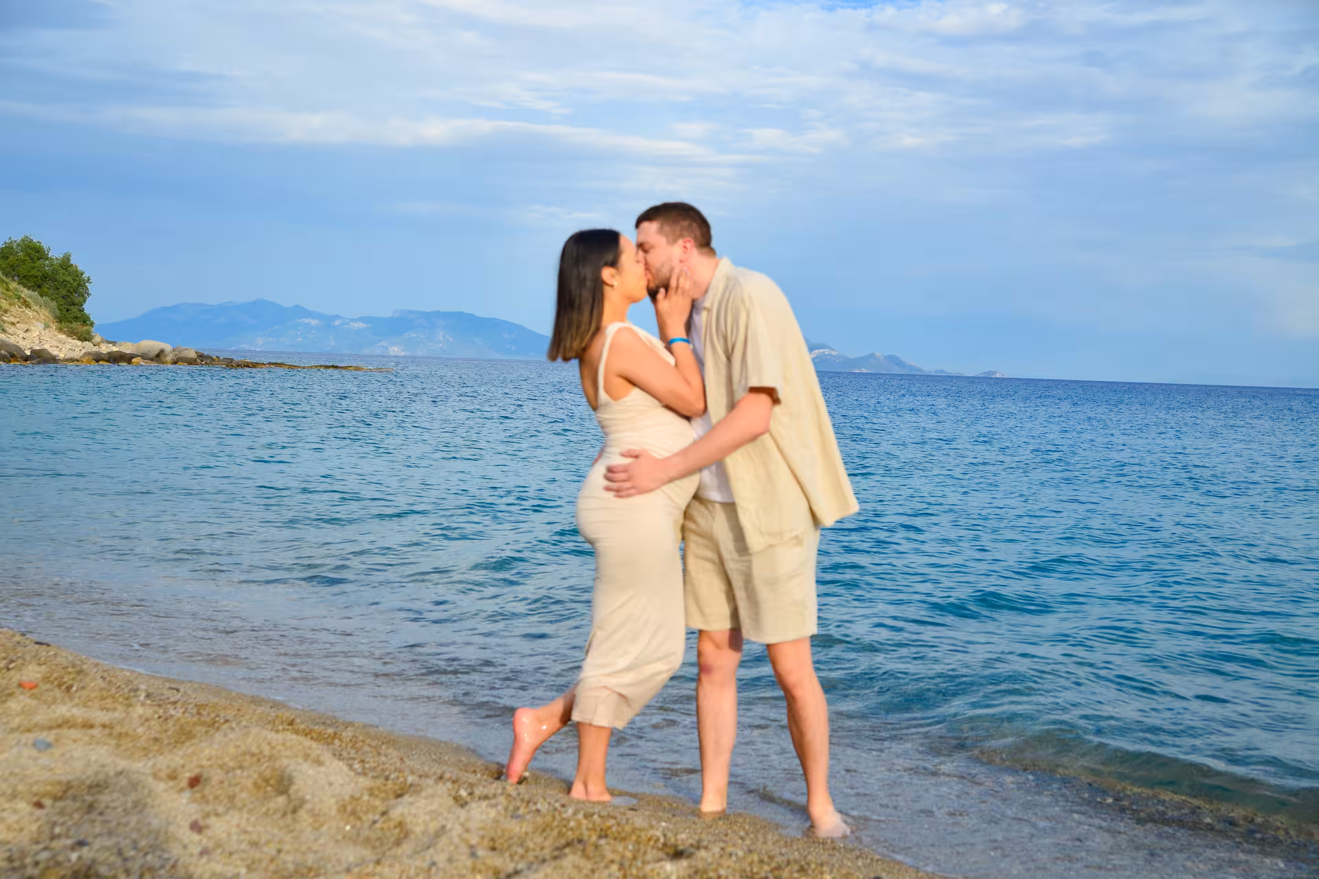 Couple shares a kiss along Heraklion's scenic coastline during an engagement photoshoot at the Venetian Port.