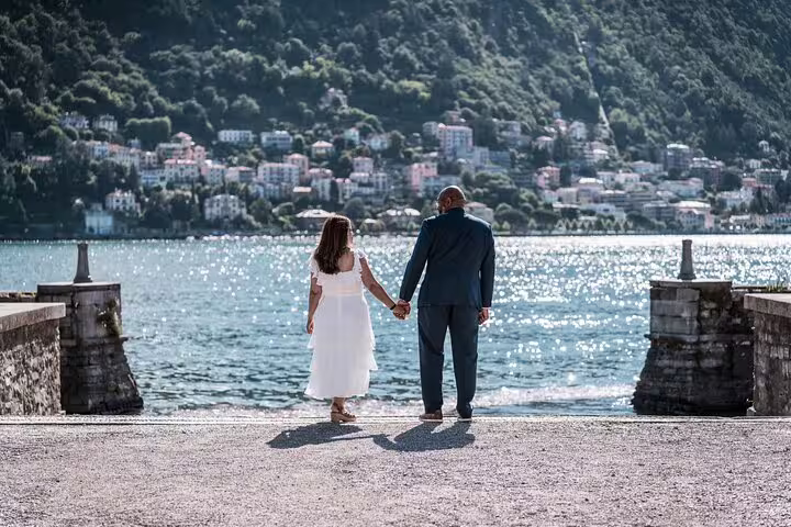 Couple holding hands by Lake Como waterfront, captured on a private tour with personal travel photographer