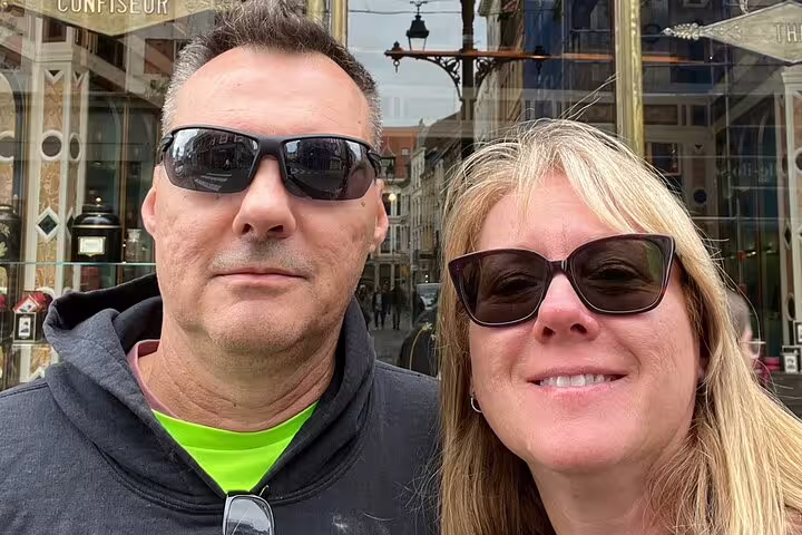 Couple selfie outside a Lille confiseur shop during Lille scavenger hunt and city highlights walking tour