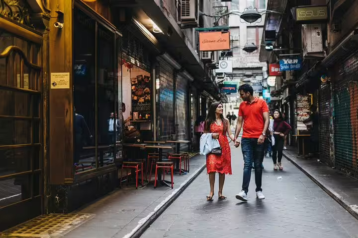 Couple walking through Melbourne laneway on a private tour with personal travel photographer, candid city photos