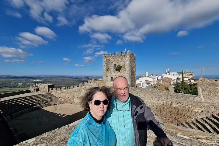 Couple exploring the historic Monsaraz Castle with panoramic views on a day trip from Lisbon to Évora and Monsaraz.