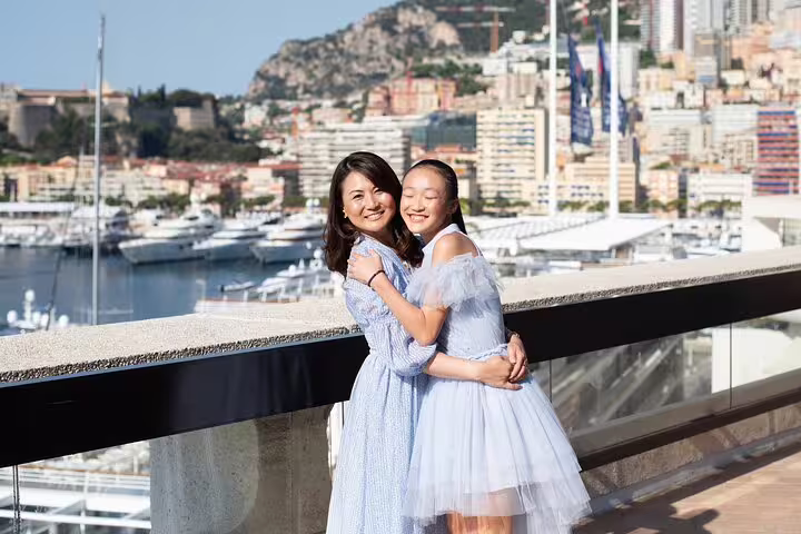 Couple hugging at Monte Carlo harbor viewpoint with yachts, captured on a private Monaco travel photographer tour