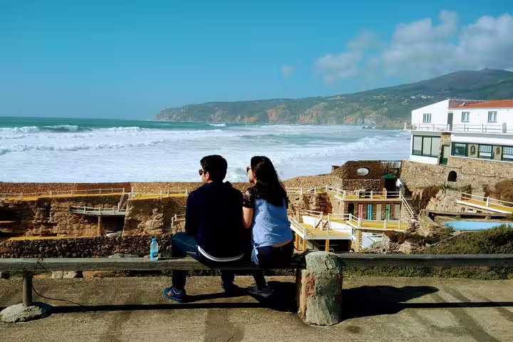 Couple enjoying ocean views in Cascais, highlighting the scenic beauty of the Sintra World Heritage and Cascais Luxury Tour.