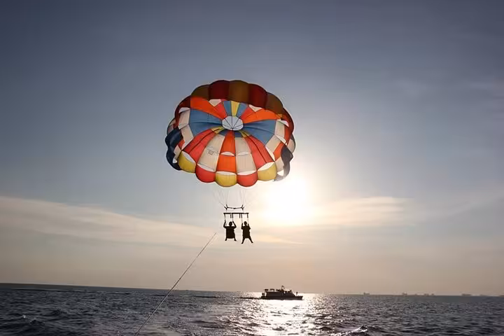 Couple parasailing in Hurghada, Red Sea adventure with boat tow and private hotel transfer included